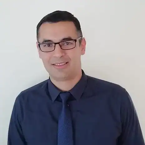 Photo of James Collier in tee on dark background