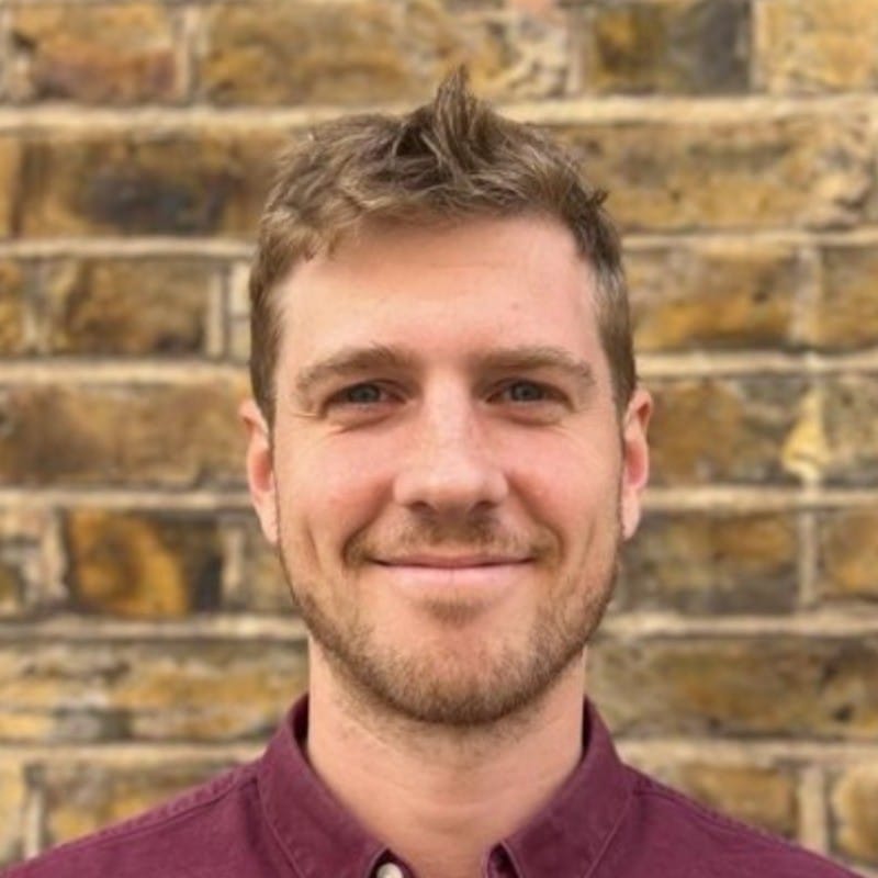 Photo of James Collier in tee on dark background