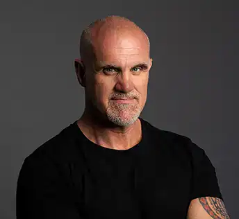 Photo of James Collier in tee on dark background